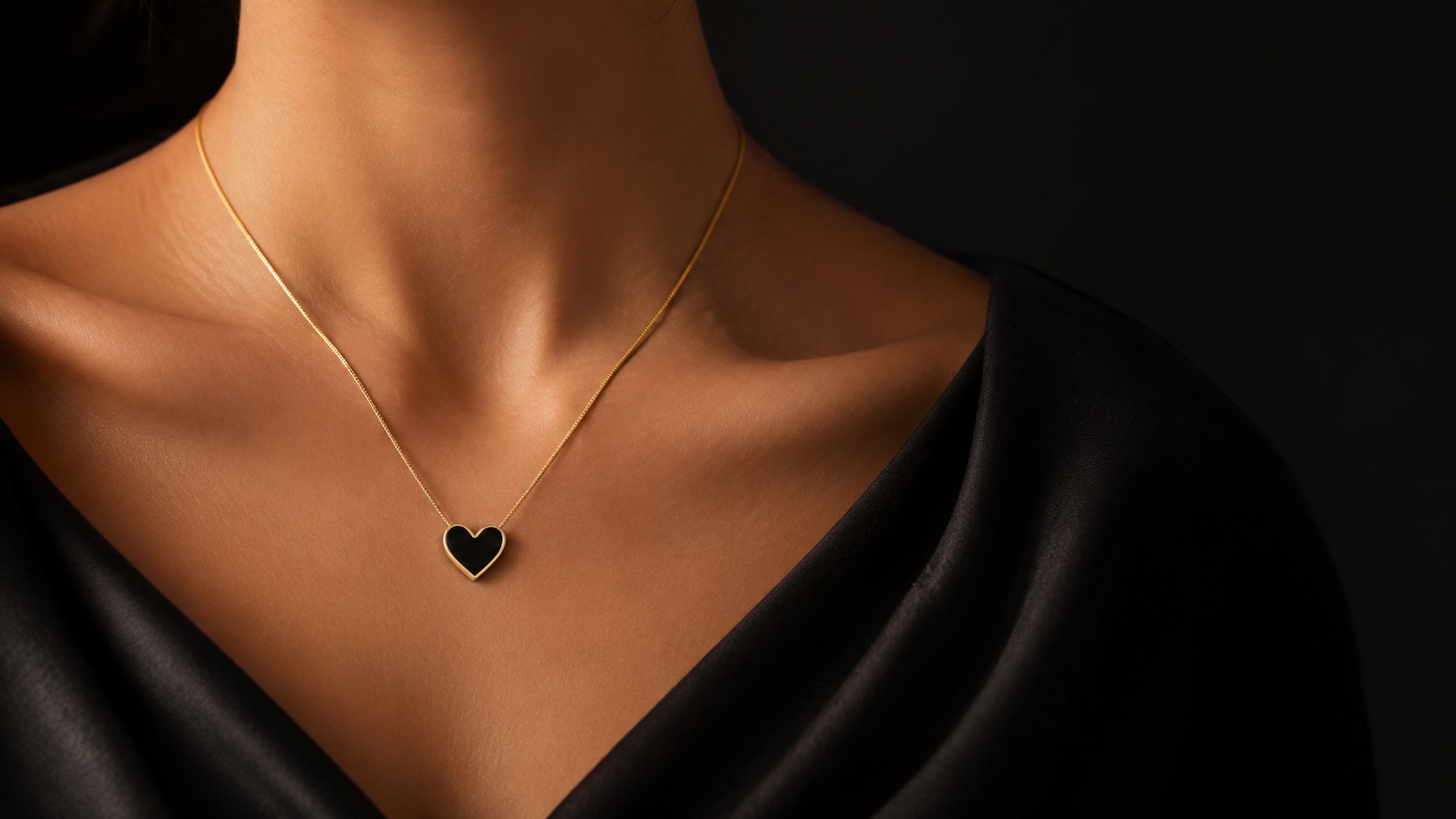 The Heart, on shell necklace worn against soft black fabric.
